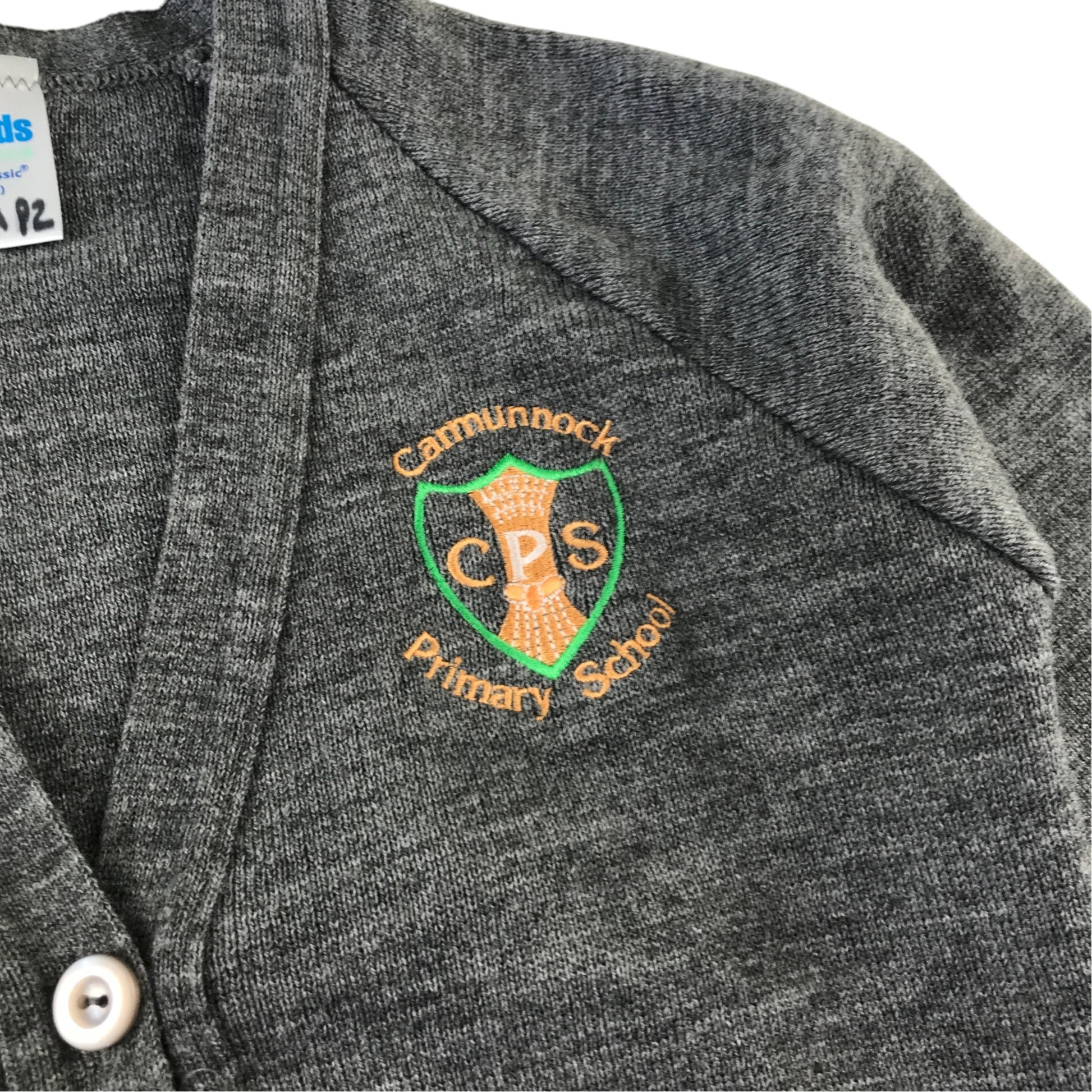 Second-hand Carmunnock Primary girls light grey knitwear school cardigan, flat lay view with embroidered badge.