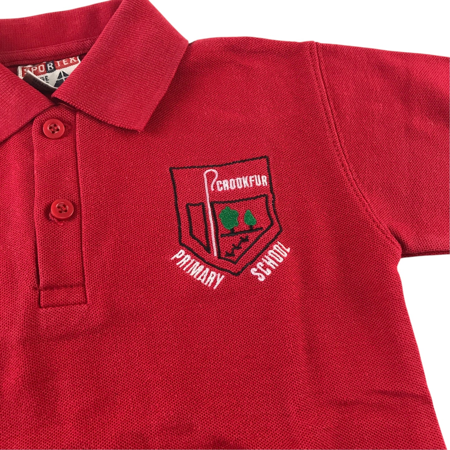 Second-hand Crookfur Primary red polo shirt, flat lay view with embroidered school badge.