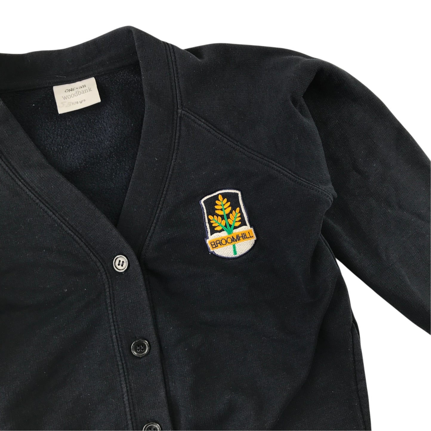 Second-hand Broomhill Primary girls navy jersey school cardigan, flat lay view with embroidered school badge.