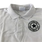 Second-hand Eastbank Primary School unisex white polo shirt, flat lay view with embroidered school badge.