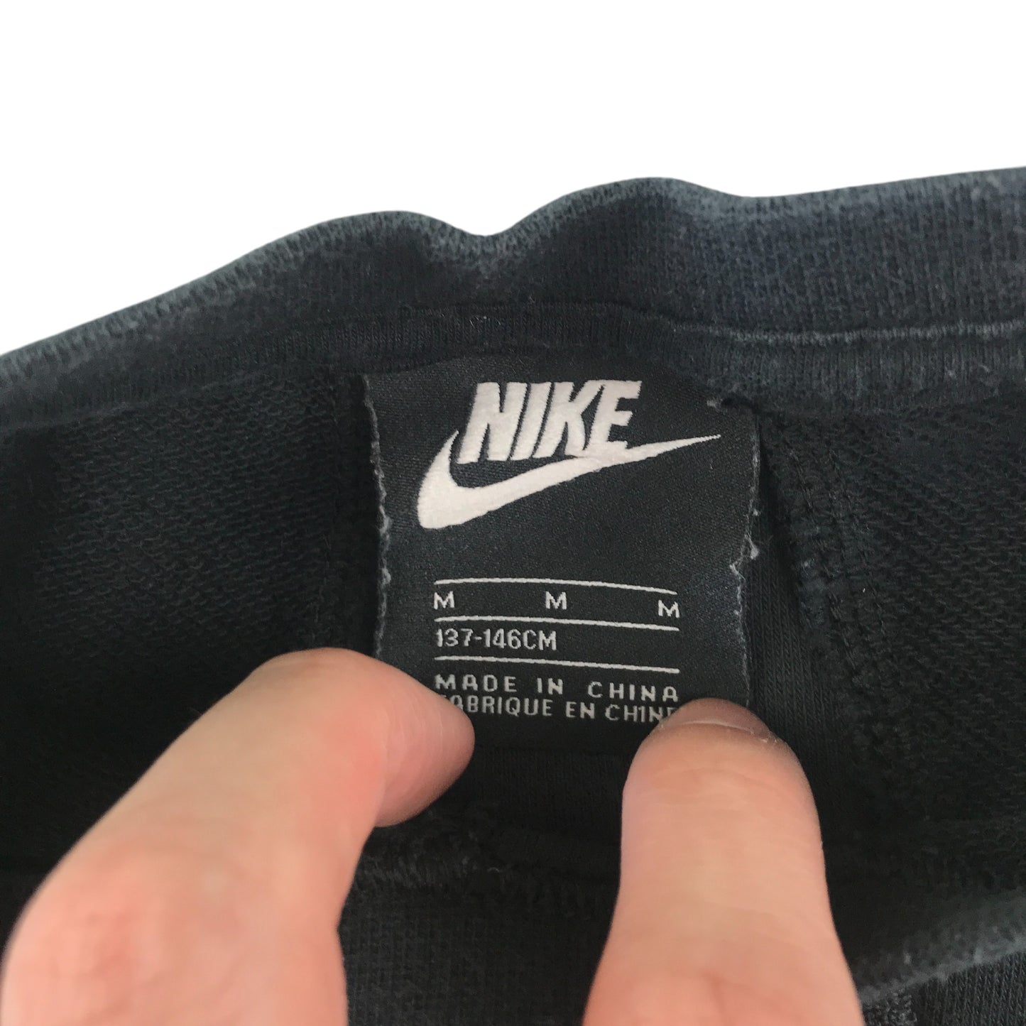 Nike sweater 9-10 years black with fleece material in triangle shape