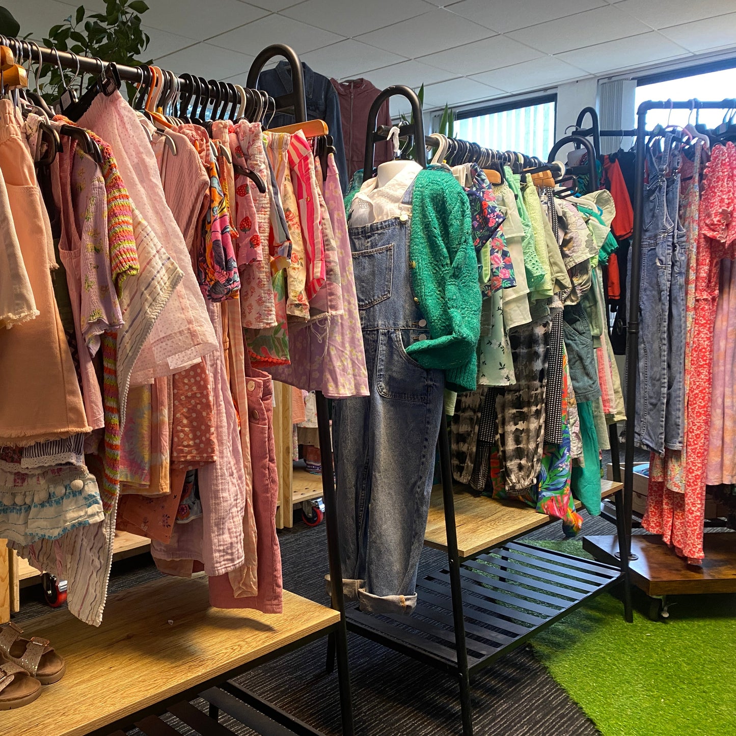 Second-hand kids clothing on hangers
