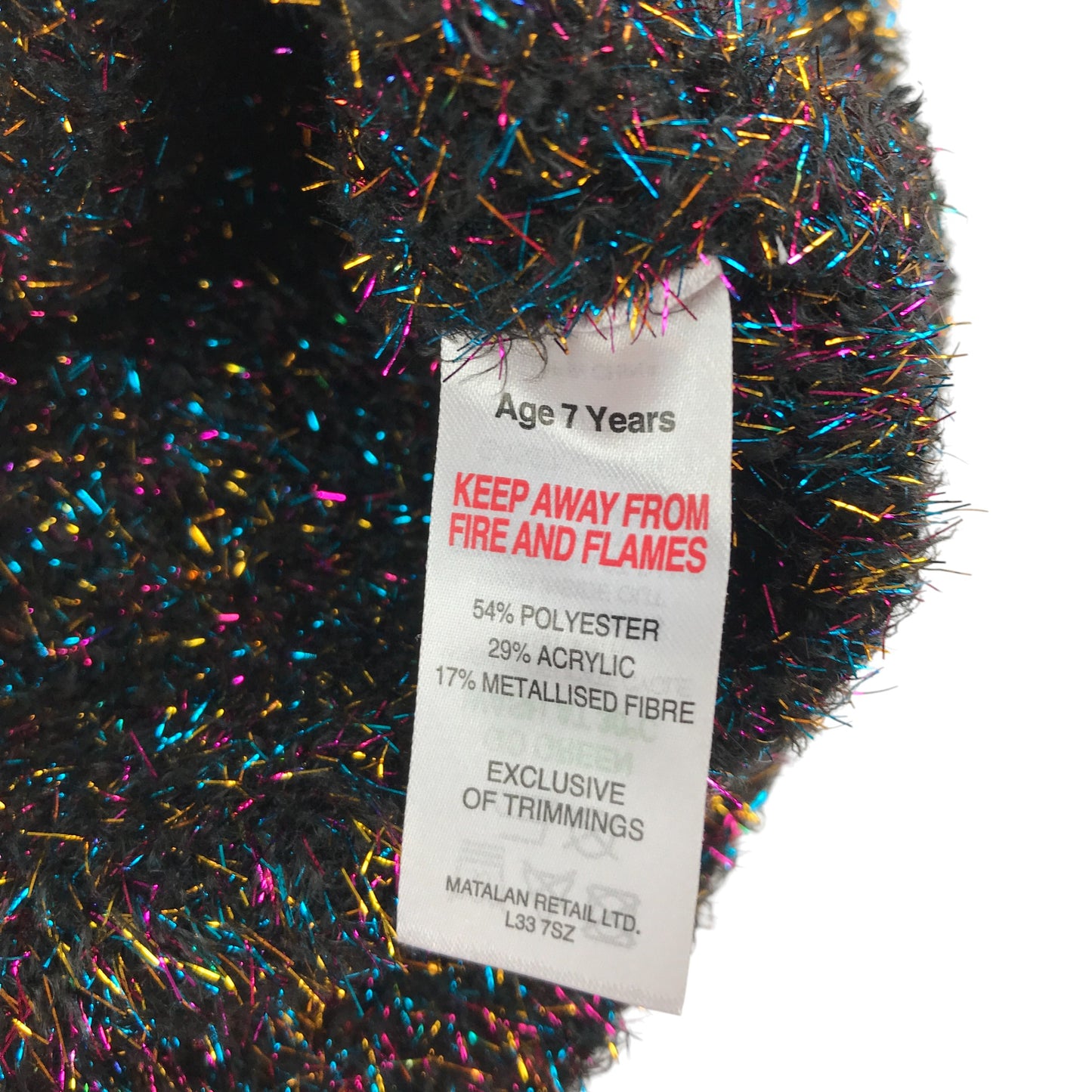 Matalan Jumper 6-7 years black with tinselly multicoloured design